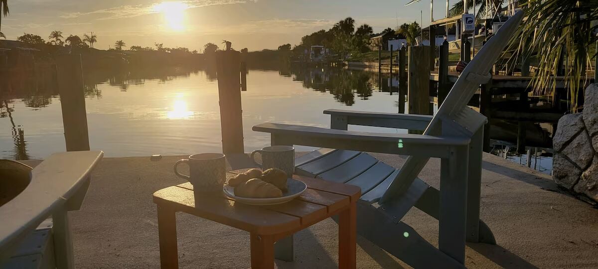 Morning coffee and croissants on the dock at sunrise