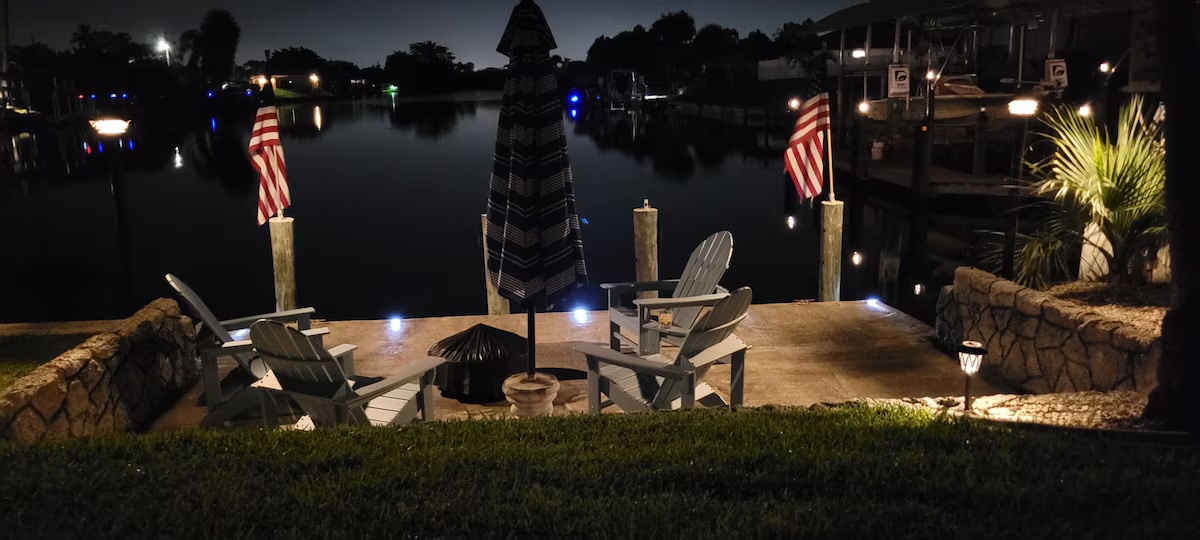 Private dock with Adirondack chairs on the canal