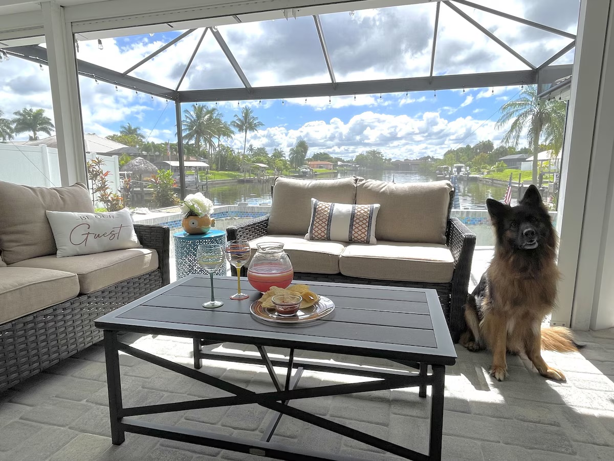 Screened patio with the family dog enjoying the canal view