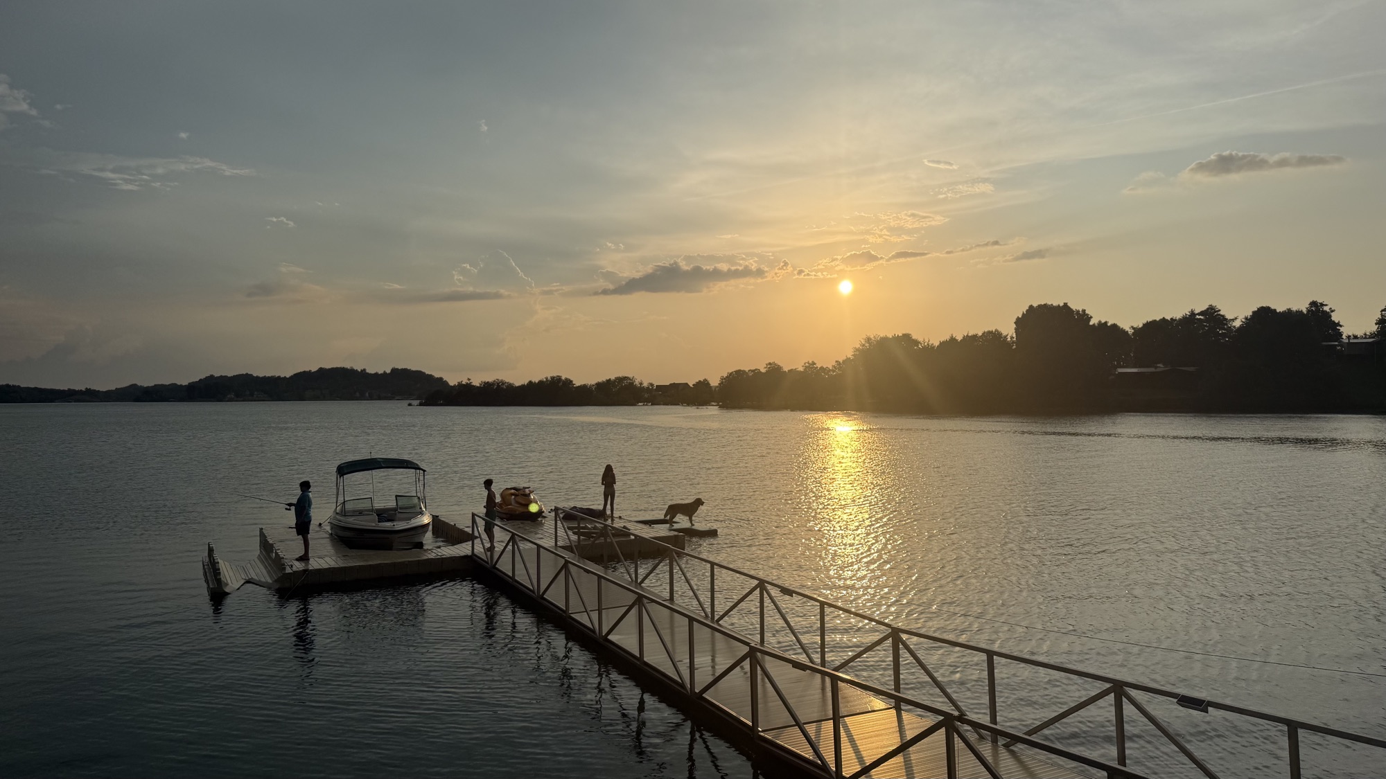 Family enjoying the floating dock at golden hour on Douglas Lake