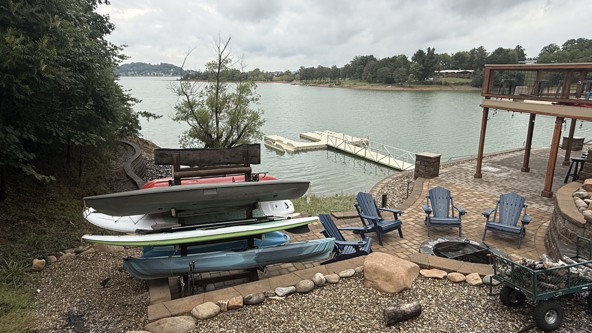 The kayak and paddle board rack on the hardscape overlooking a still, quiet Douglas Lake